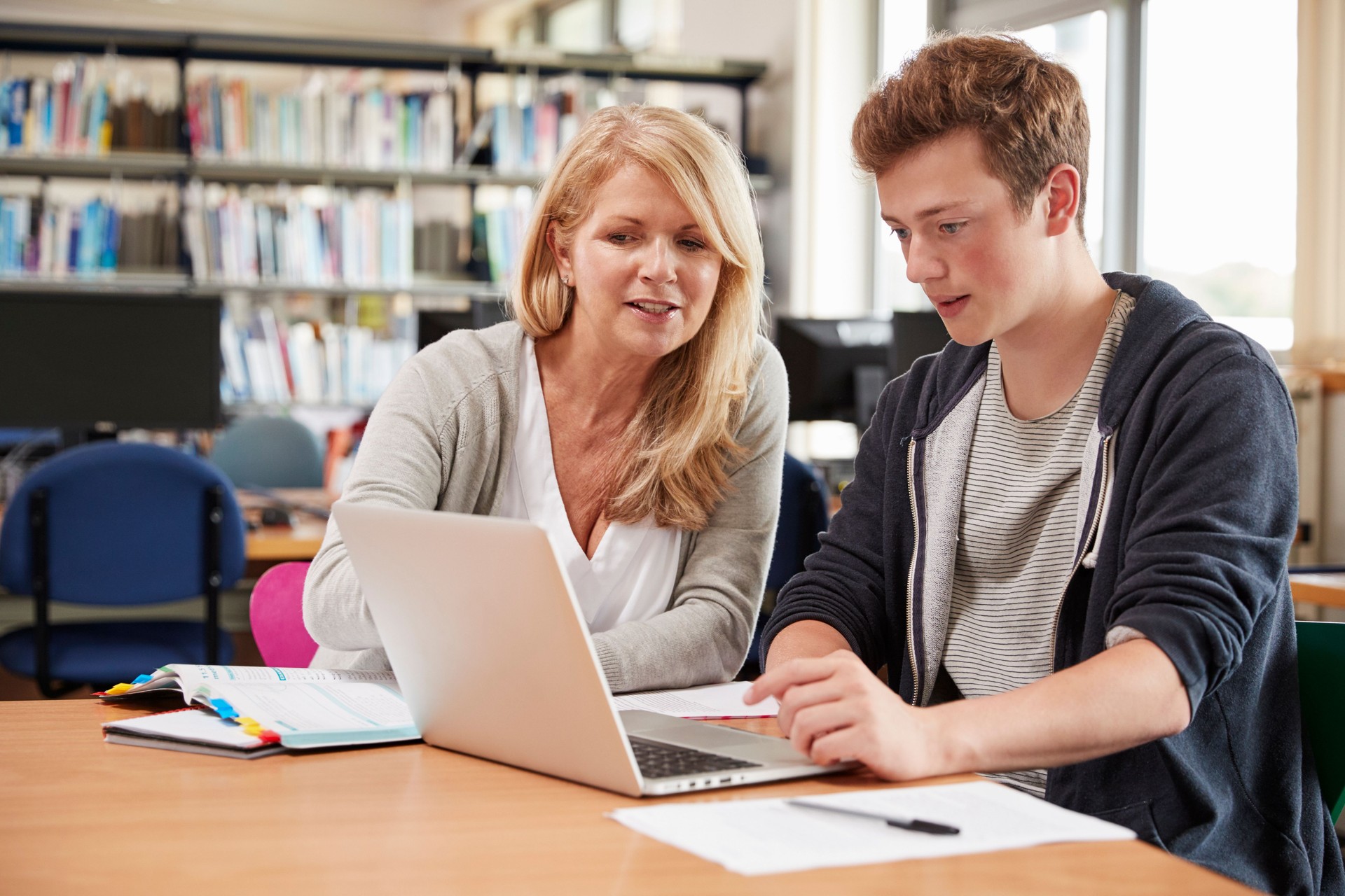 College Student Has Individual Tuition From Teacher In Library
