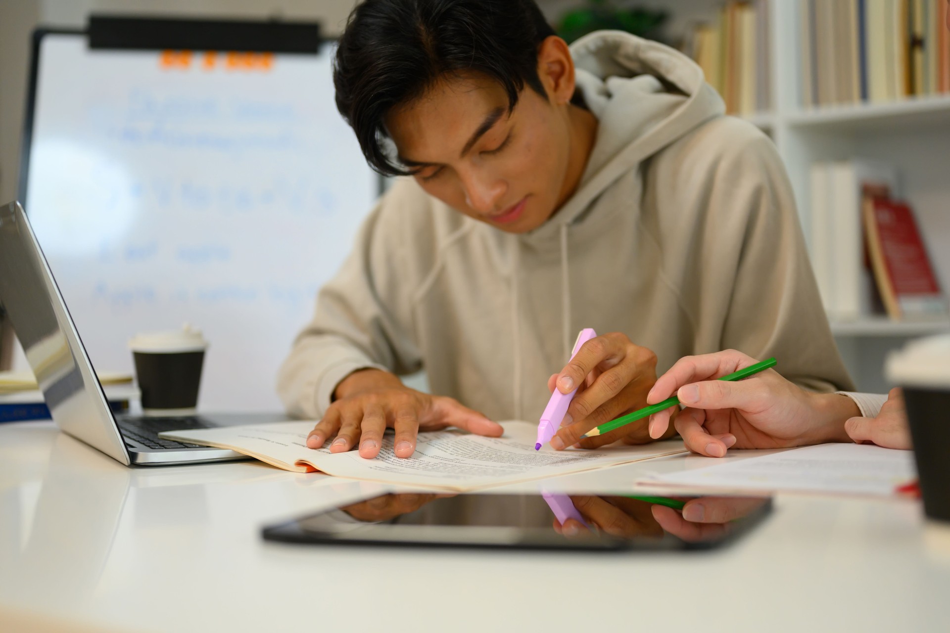 Asian male student studying with tutor at home. Education, knowledge and tutoring concept